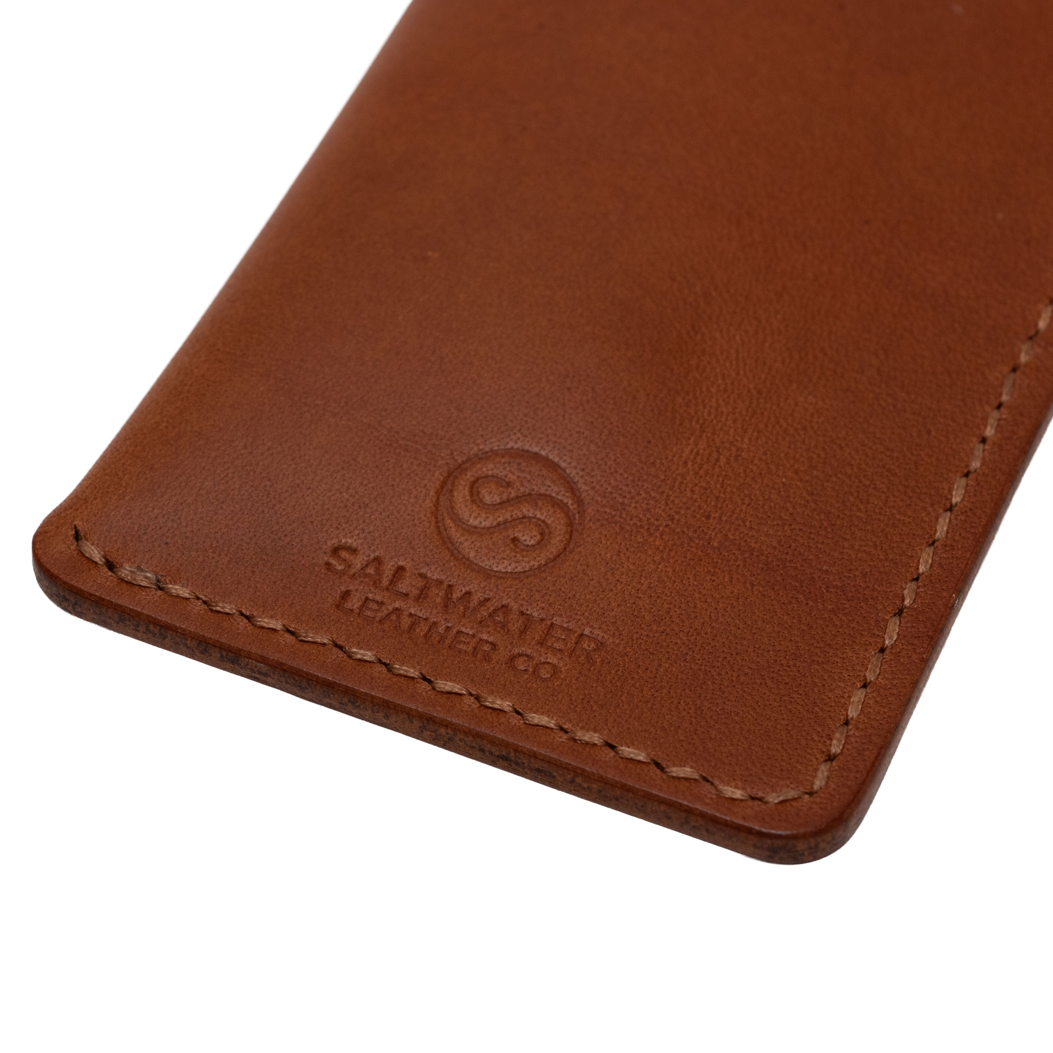 Brown leather wallet with Saltwater Leather branding on a white background