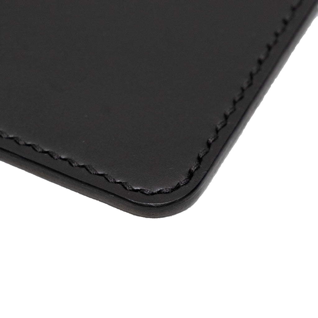 Close up of a black passport holder on a white background