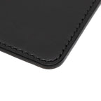 Close up of a black passport holder on a white background