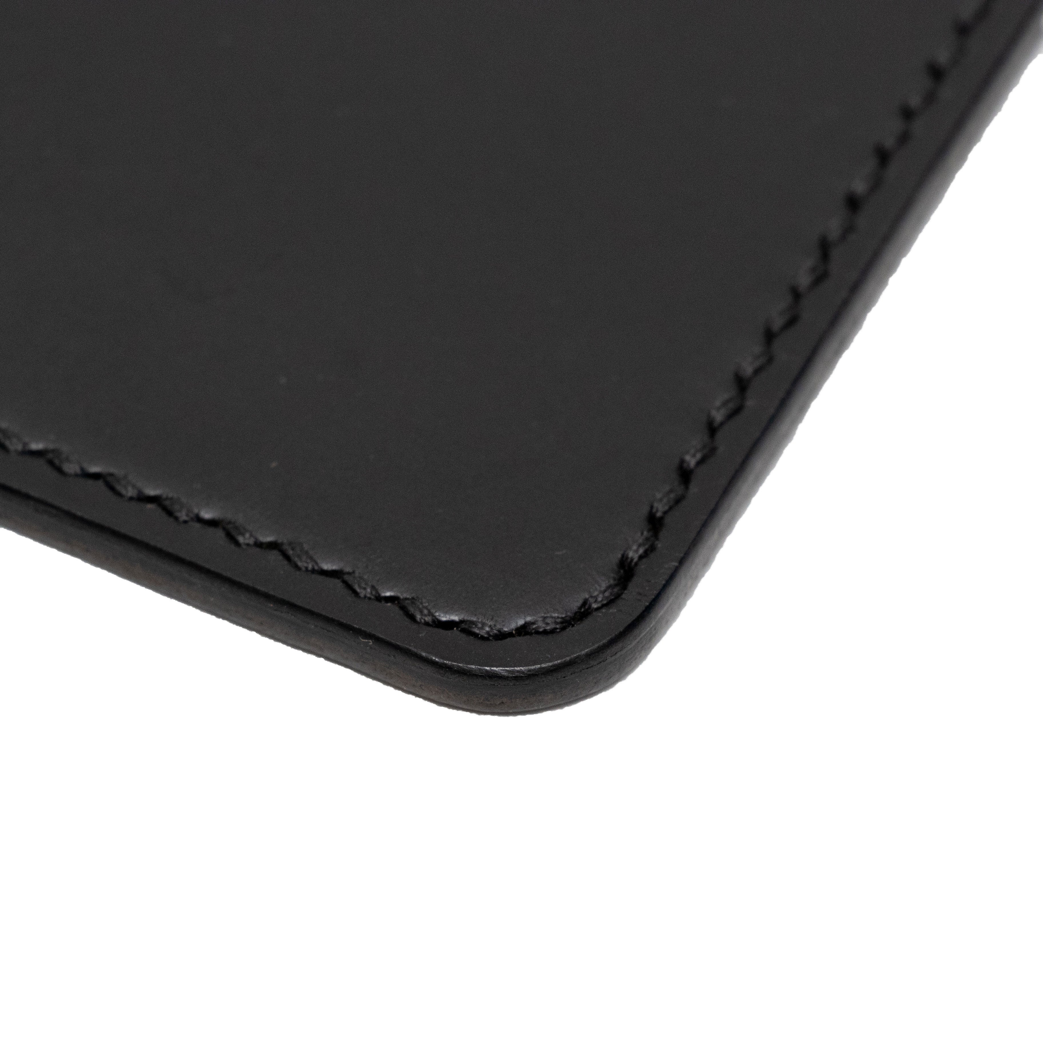 Close up of a black passport holder on a white background