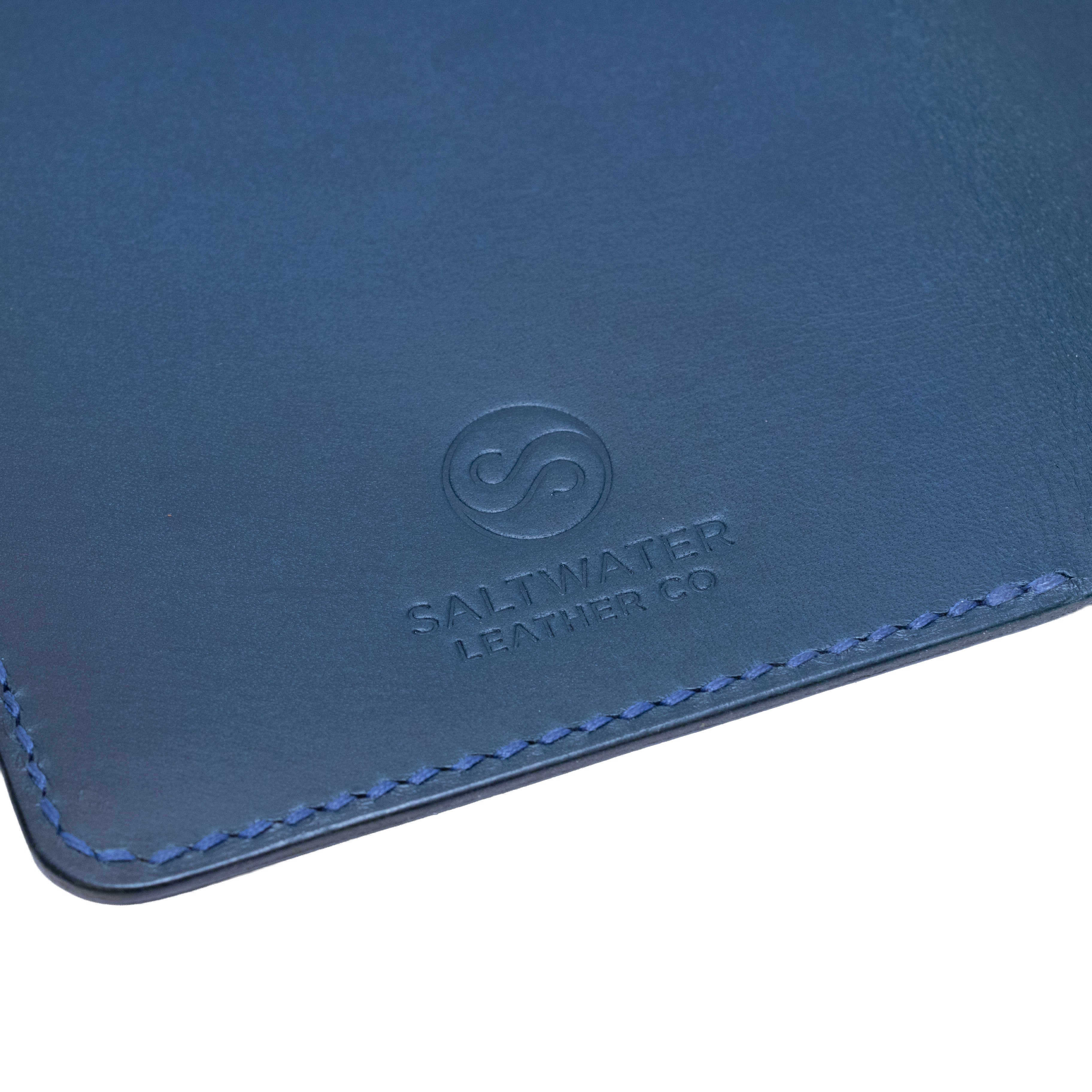 Close-up of a blue leather product with Saltwater Leather branding.