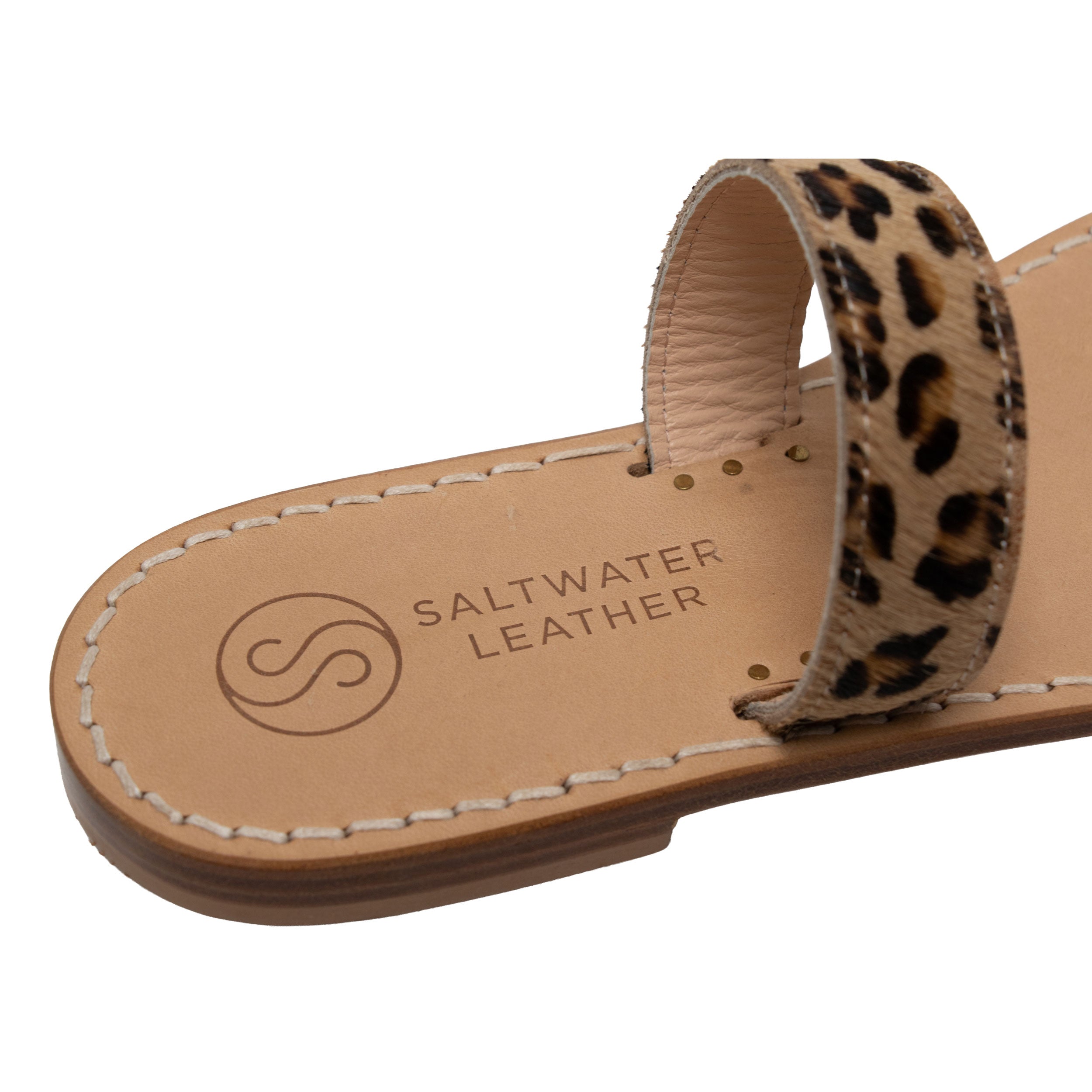 Sandal with leopard print strap and 'Saltwater Leather' branding on a white background