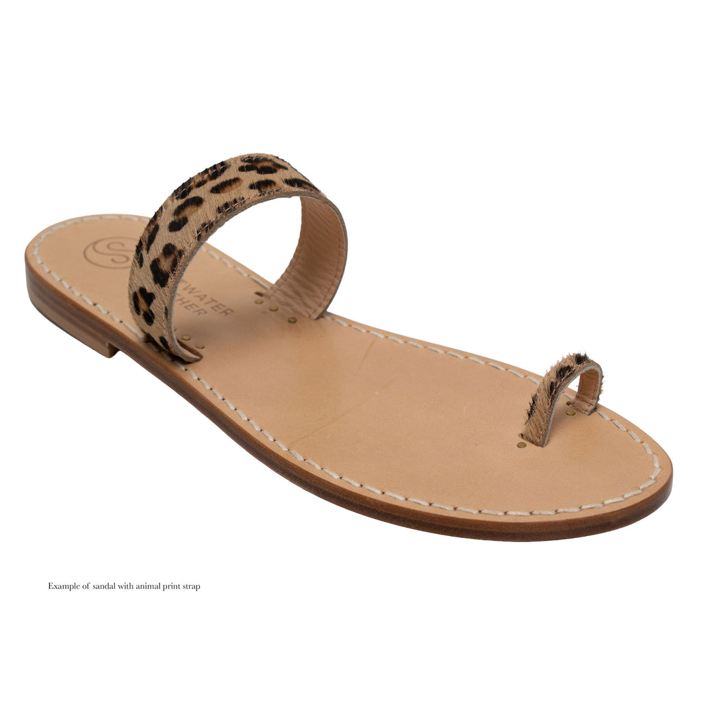Tan sandal with a leopard print strap on a white background