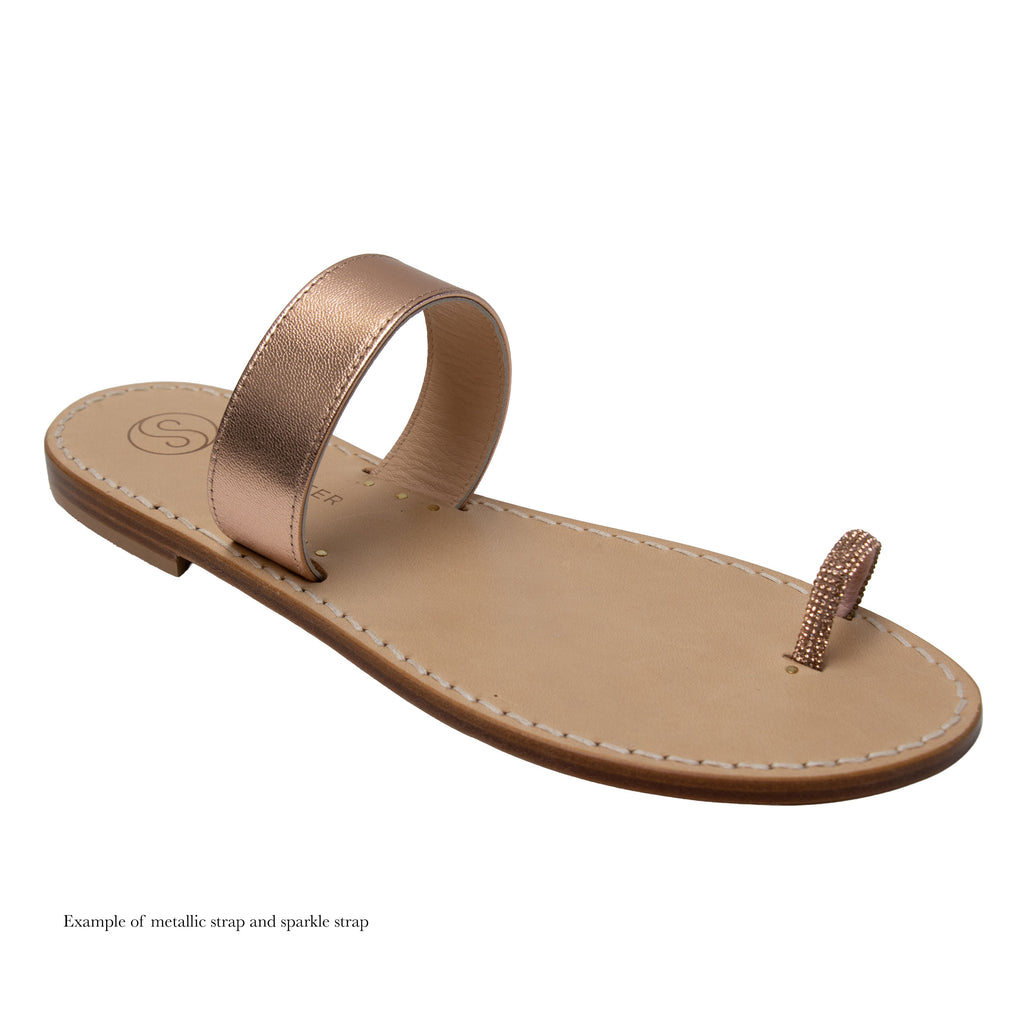Beige sandal with metallic strap on a white background