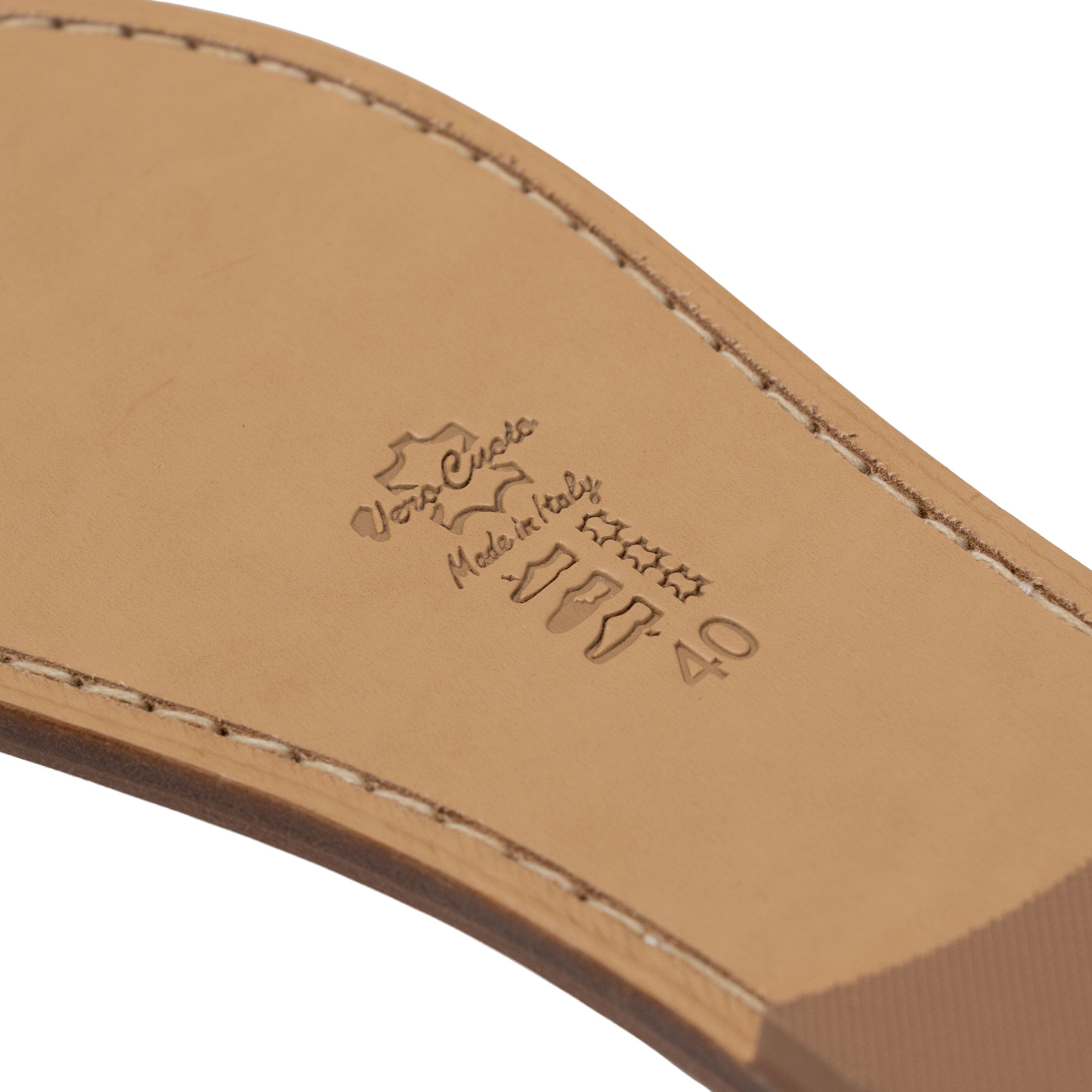 Close-up of a natural bottom of a sandal with a brand logo on a white background