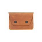Brown leather wallet with two black buttons on a white background