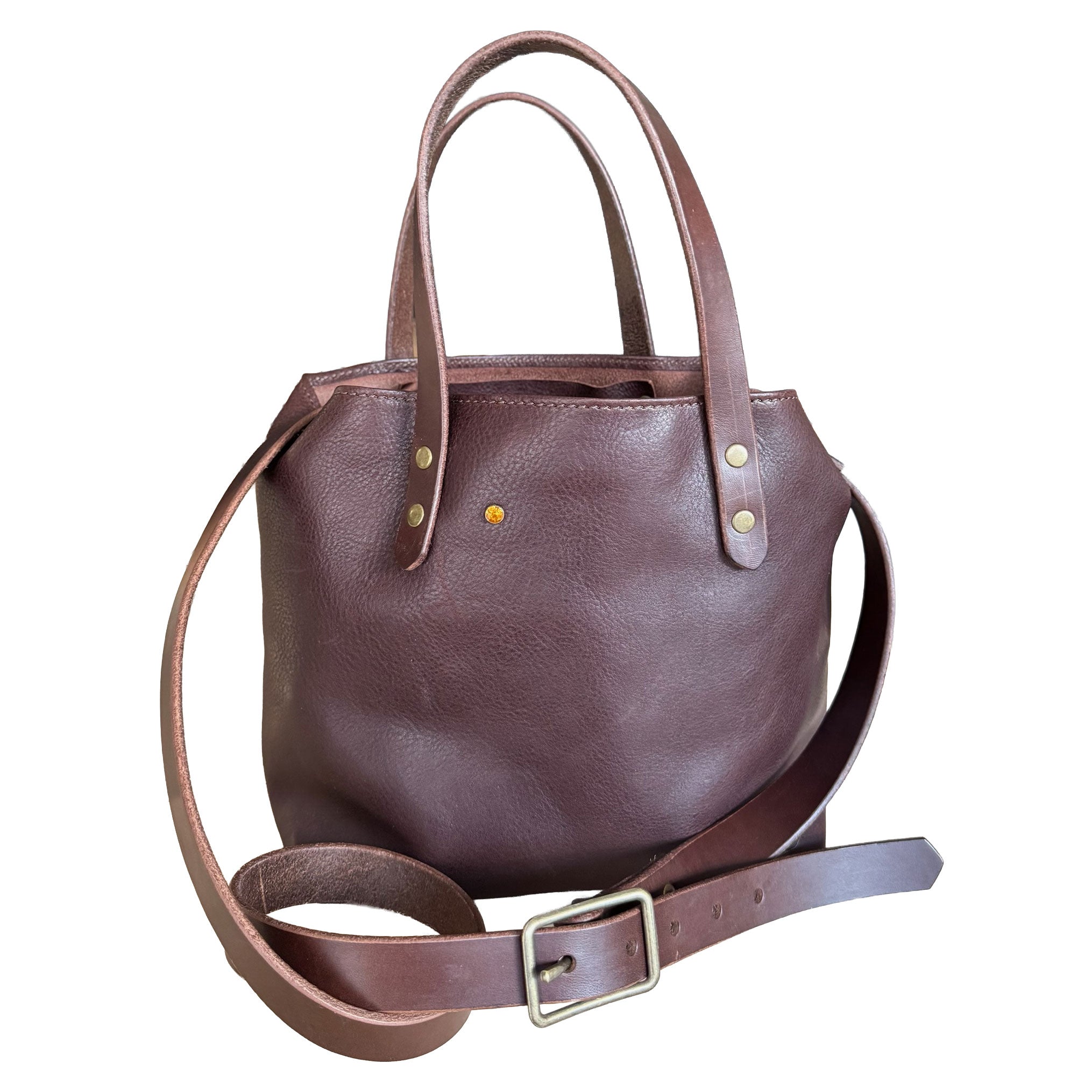 Brown leather handbag with a strap on a white background