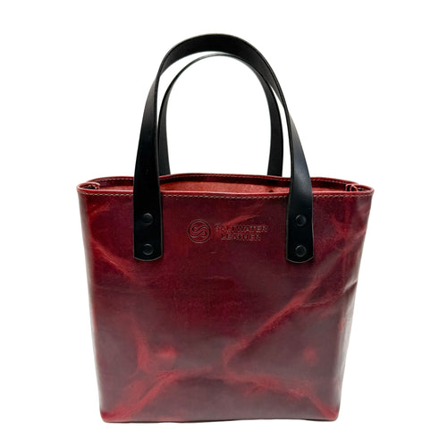 Red tote bag with black handles on a white background
