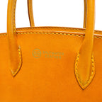 Close-up of an orange leather handbag with 'Saltwater Leather' branding.
