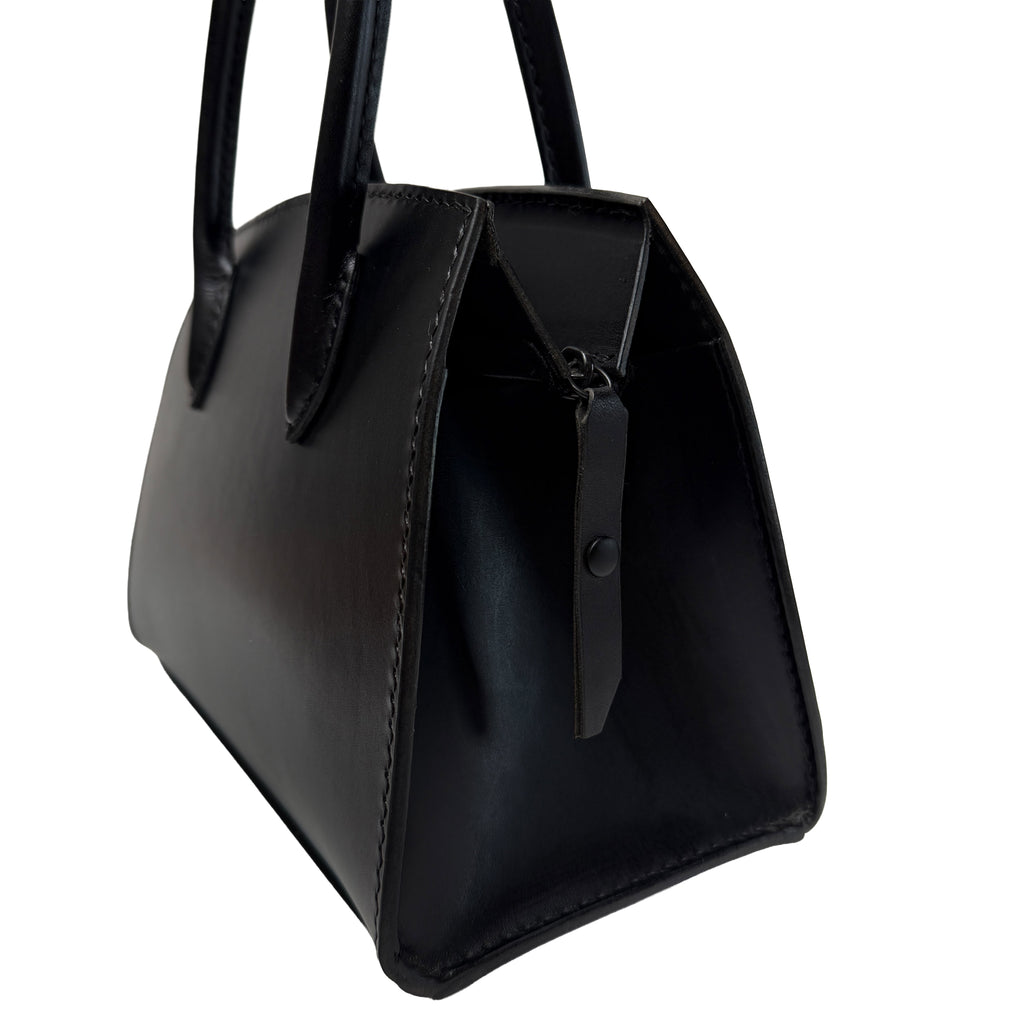 Black handbag with a zipper on a white background