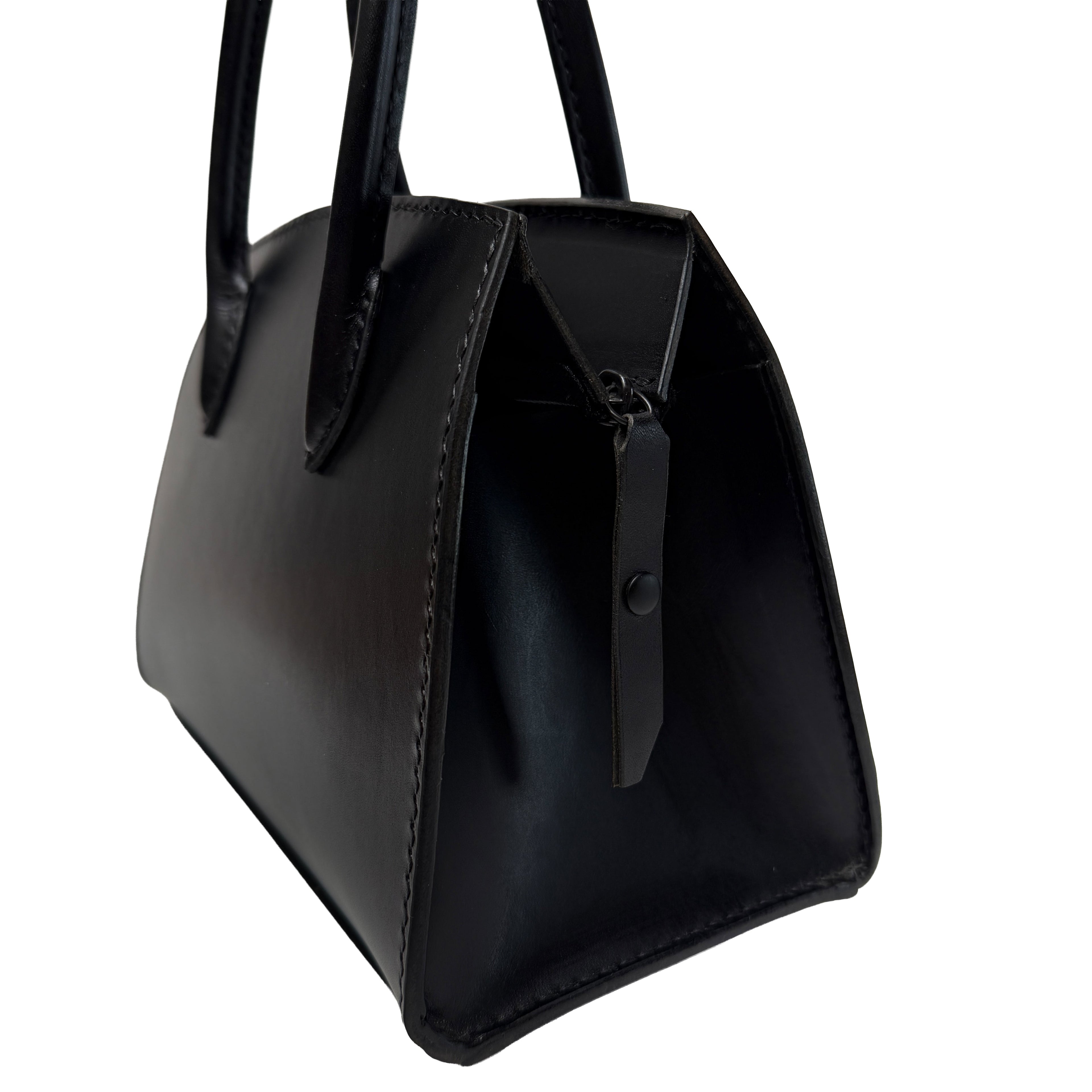 Black handbag with a zipper on a white background