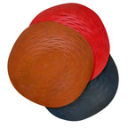 Red, brown, and blue woven leather bag flat on a white background