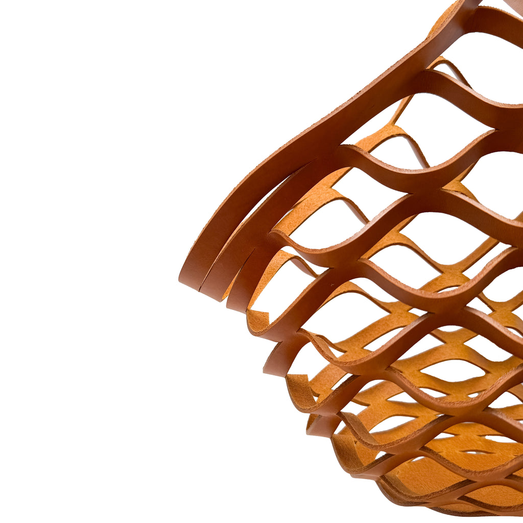 Close-up of a yellow leather woven basket on a white background
