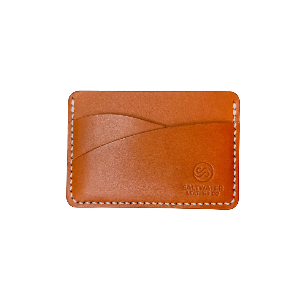 Brown leather cardholder with visible branding on a white background