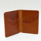 Brown leather wallet with stitching detail on a white background