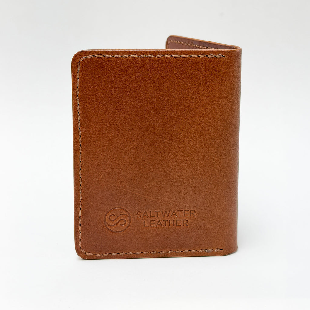 Brown leather wallet with 'Saltwater Leather' branding on a white background
