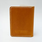 Yellow leather wallet with 'Saltwater Leather' branding on a white background