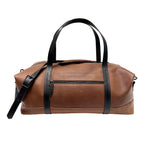 Brown leather duffle bag with black straps on a white background