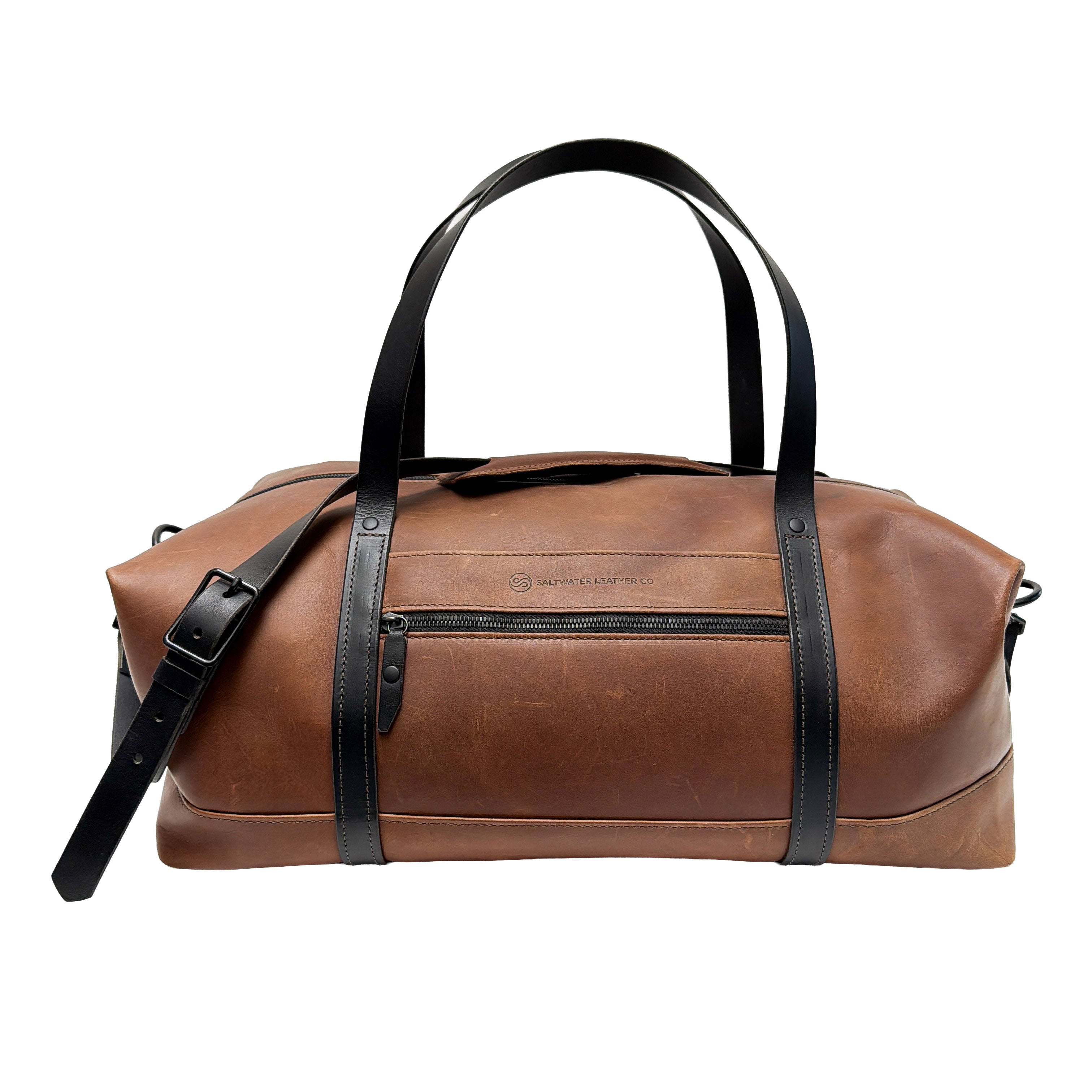 Brown leather duffle bag with black straps on a white background