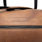 Brown leather duffle bag with Saltwater Leather logo on a white background
