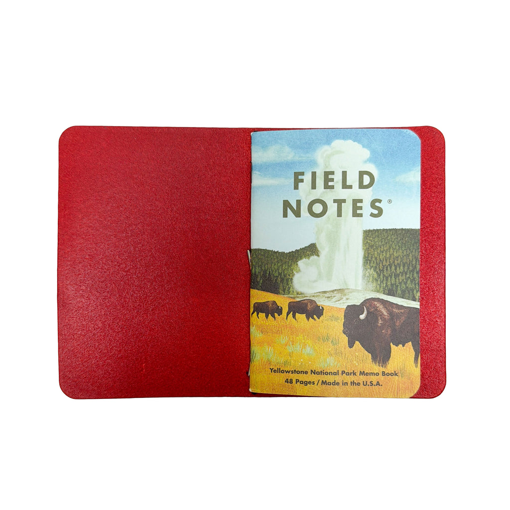 Interior of a Saltwater Leather journal cover in Cherry red holding a Field Notes memo book, open against a white background.