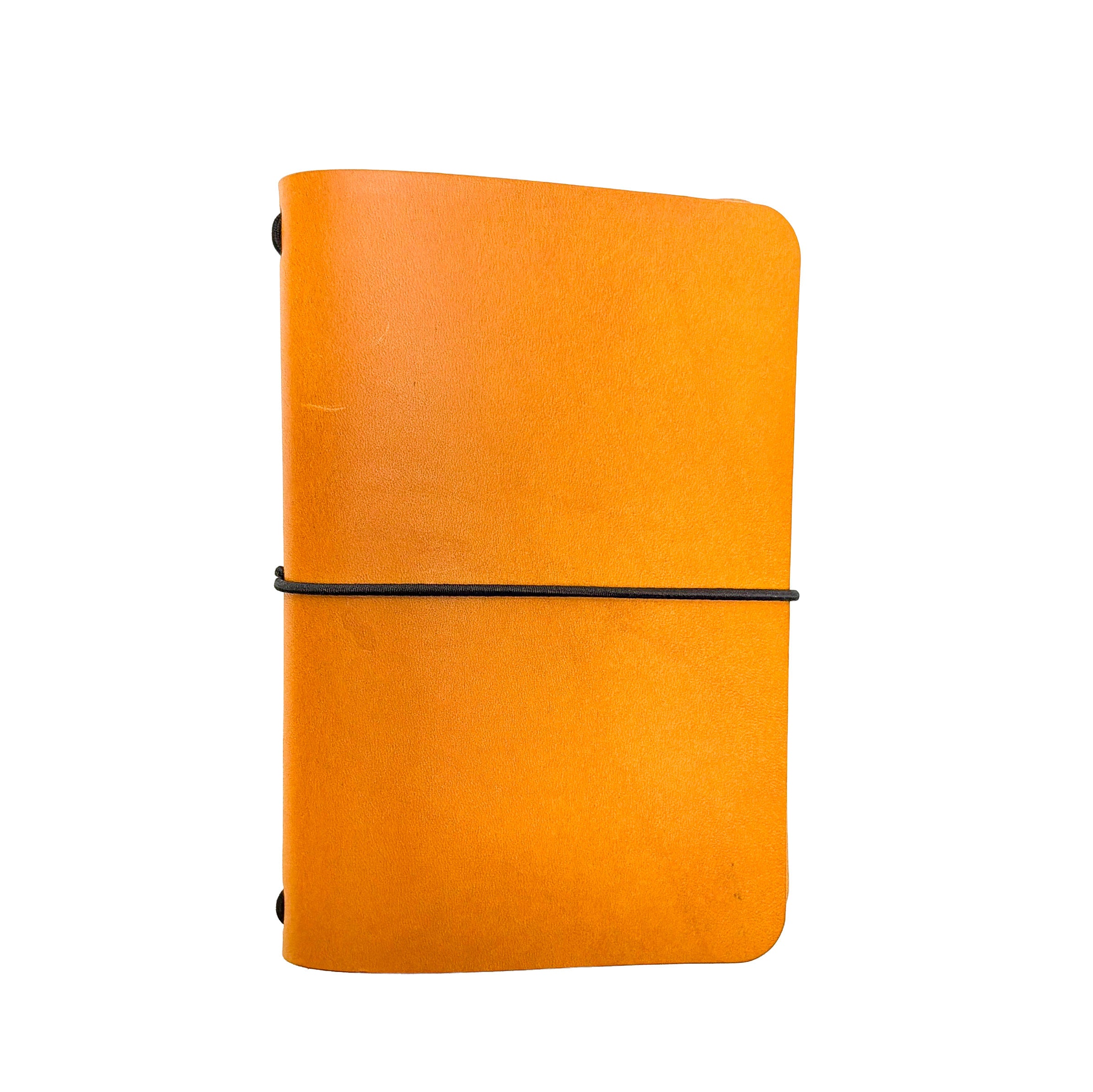 Saltwater Leather vegetable tanned leather journal cover in Mustard yellow with an elastic band closure, photographed against a white background.
