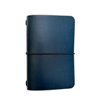 Saltwater Leather vegetable tanned leather journal cover in Pacific blue with an elastic band closure, photographed against a white background.