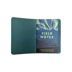 Interior of a Saltwater Leather journal cover in Pacific blue holding a Field Notes Denali National Park memo book, open against a white background.