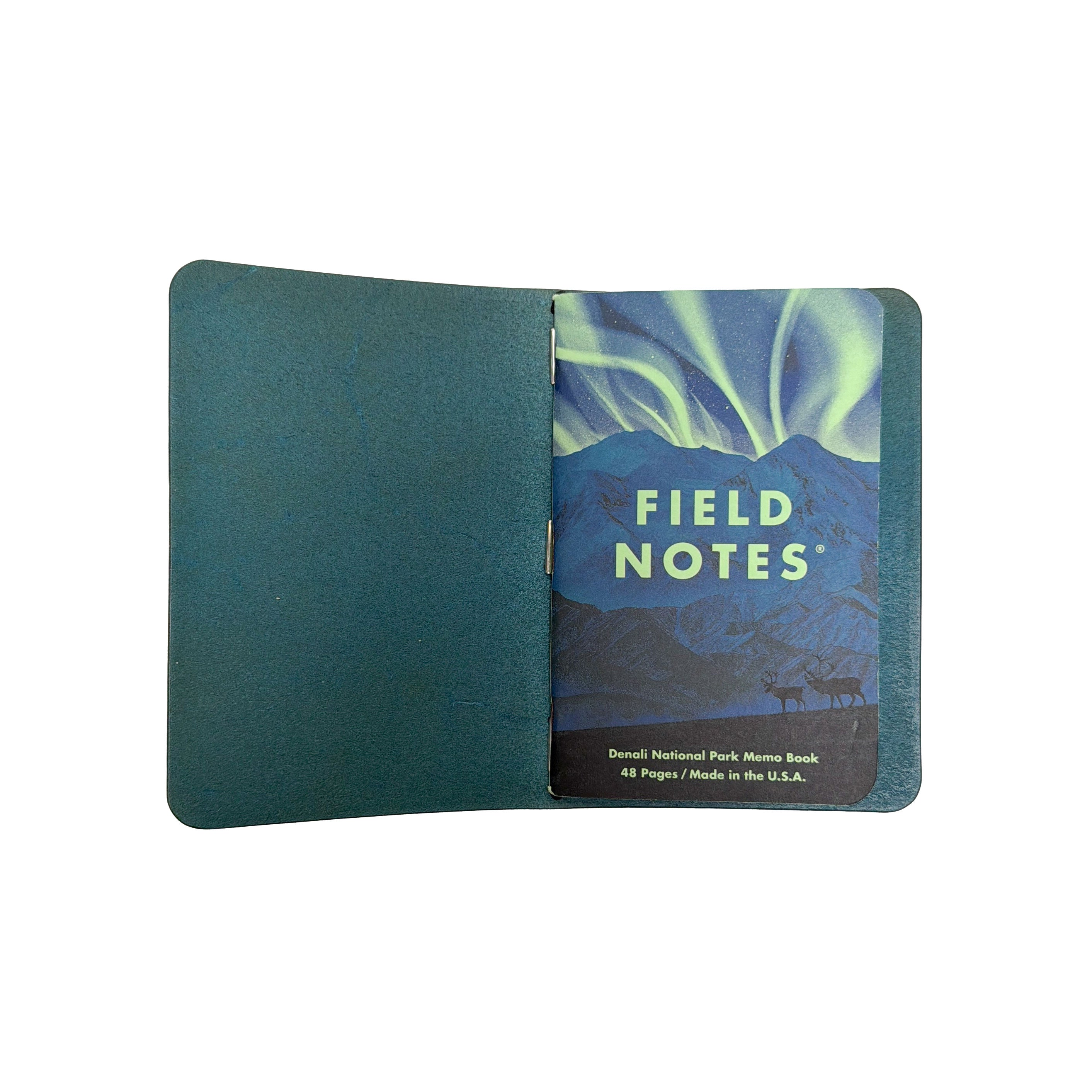 Interior of a Saltwater Leather journal cover in Pacific blue holding a Field Notes Denali National Park memo book, open against a white background.