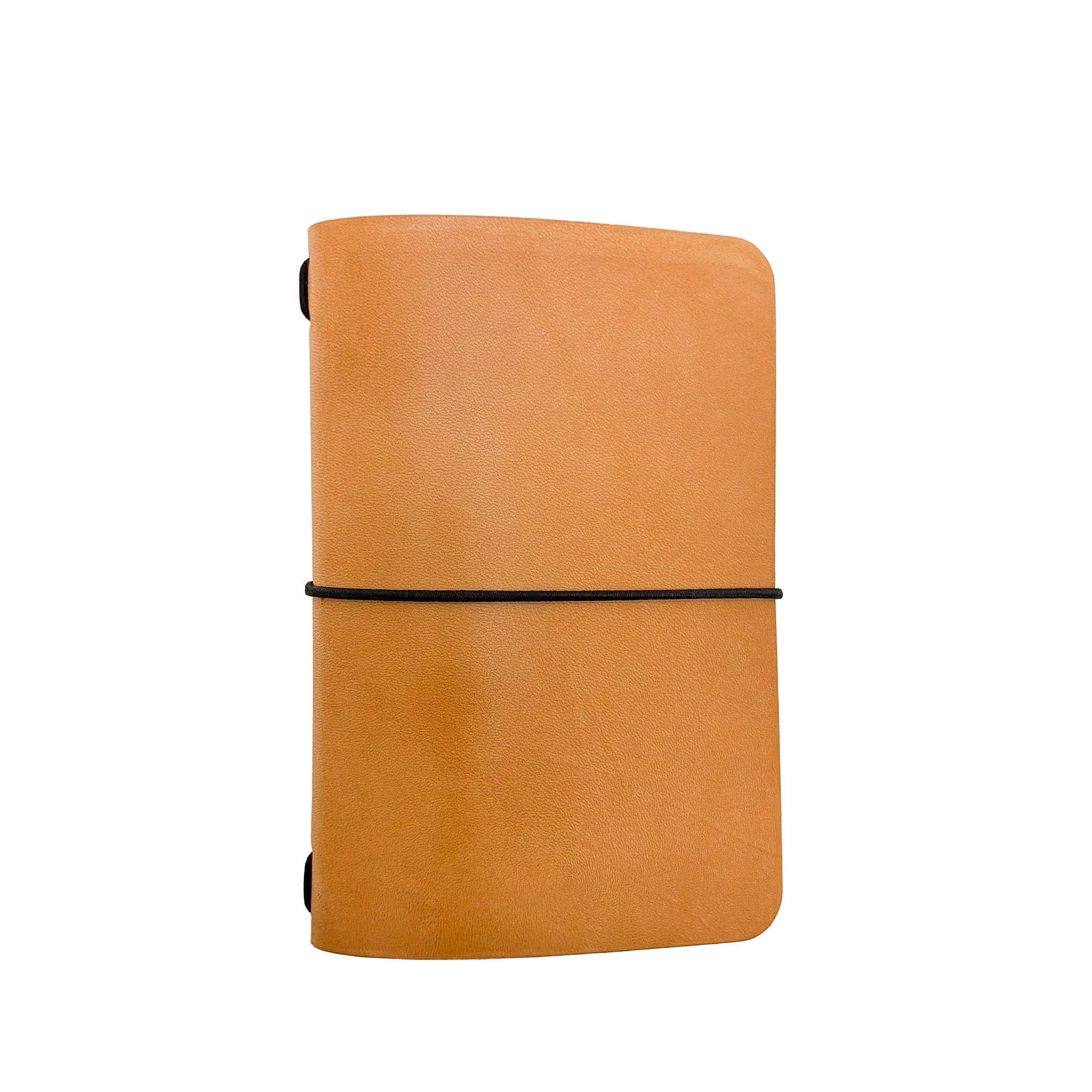 Saltwater Leather vegetable tanned leather journal cover in Natural with an elastic band closure, photographed against a white background.