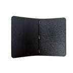 Interior of a Saltwater Leather Midnight black journal cover open against a white background.