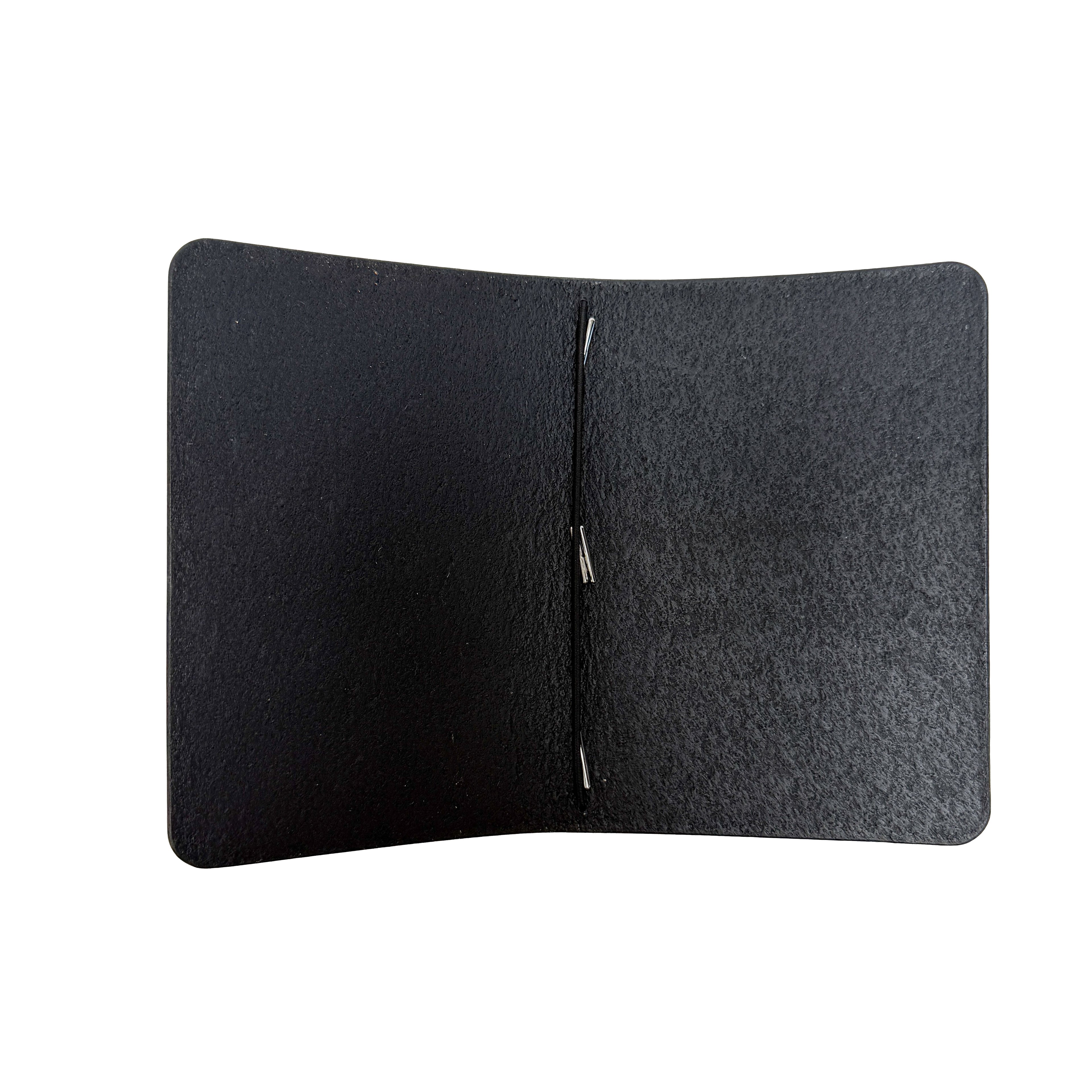 Interior of a Saltwater Leather Midnight black journal cover open against a white background.