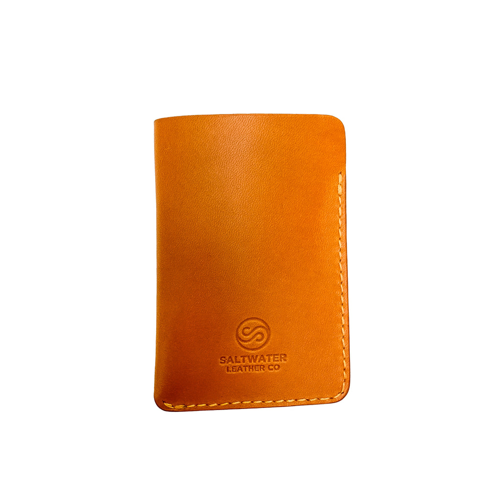 Yellow leather wallet with Saltwater Leather branding on a white background