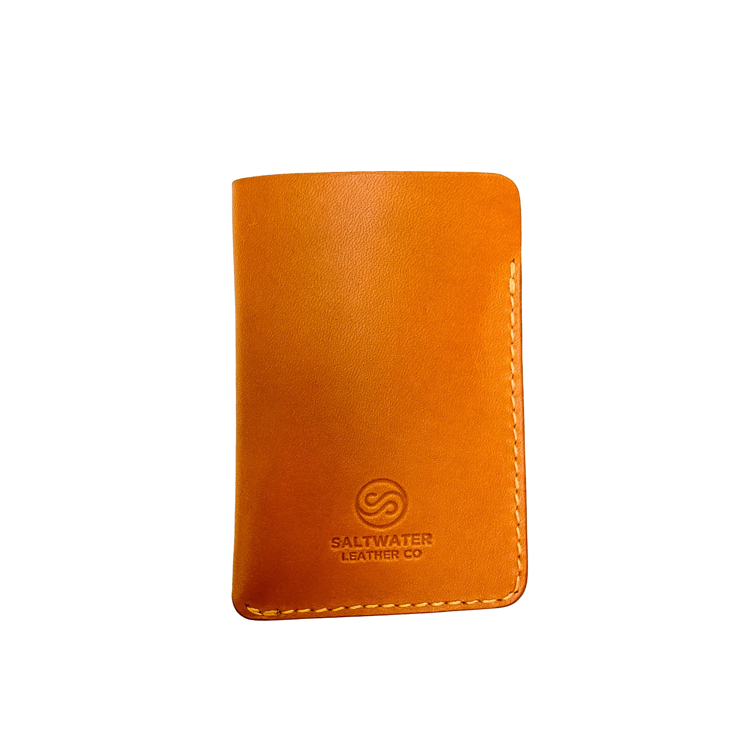 Yellow leather wallet with Saltwater Leather branding on a white background