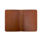 Brown leather passport holder on a white background