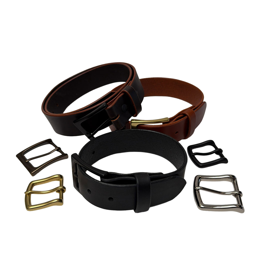 Three leather belts with different buckles on a white background
