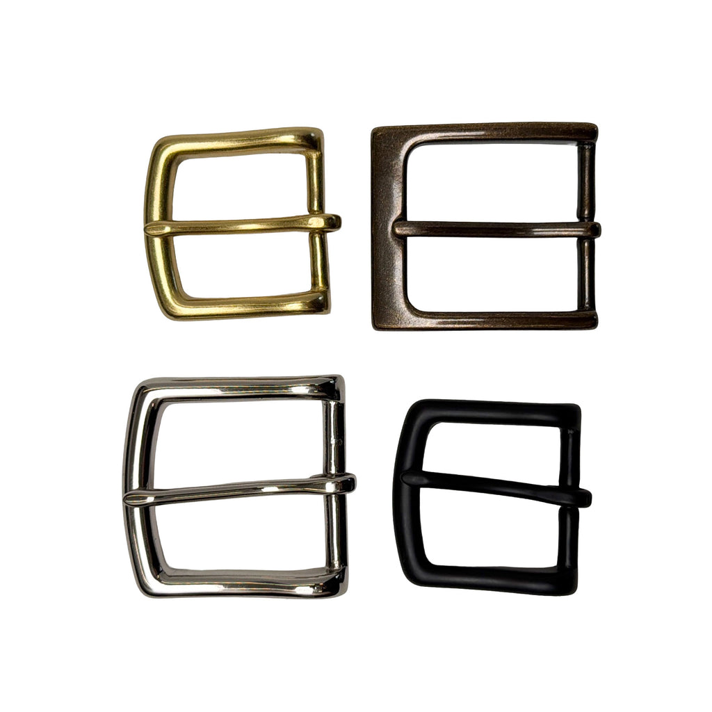 Four metal belt buckles in gold, bronze, silver, and black on a white background