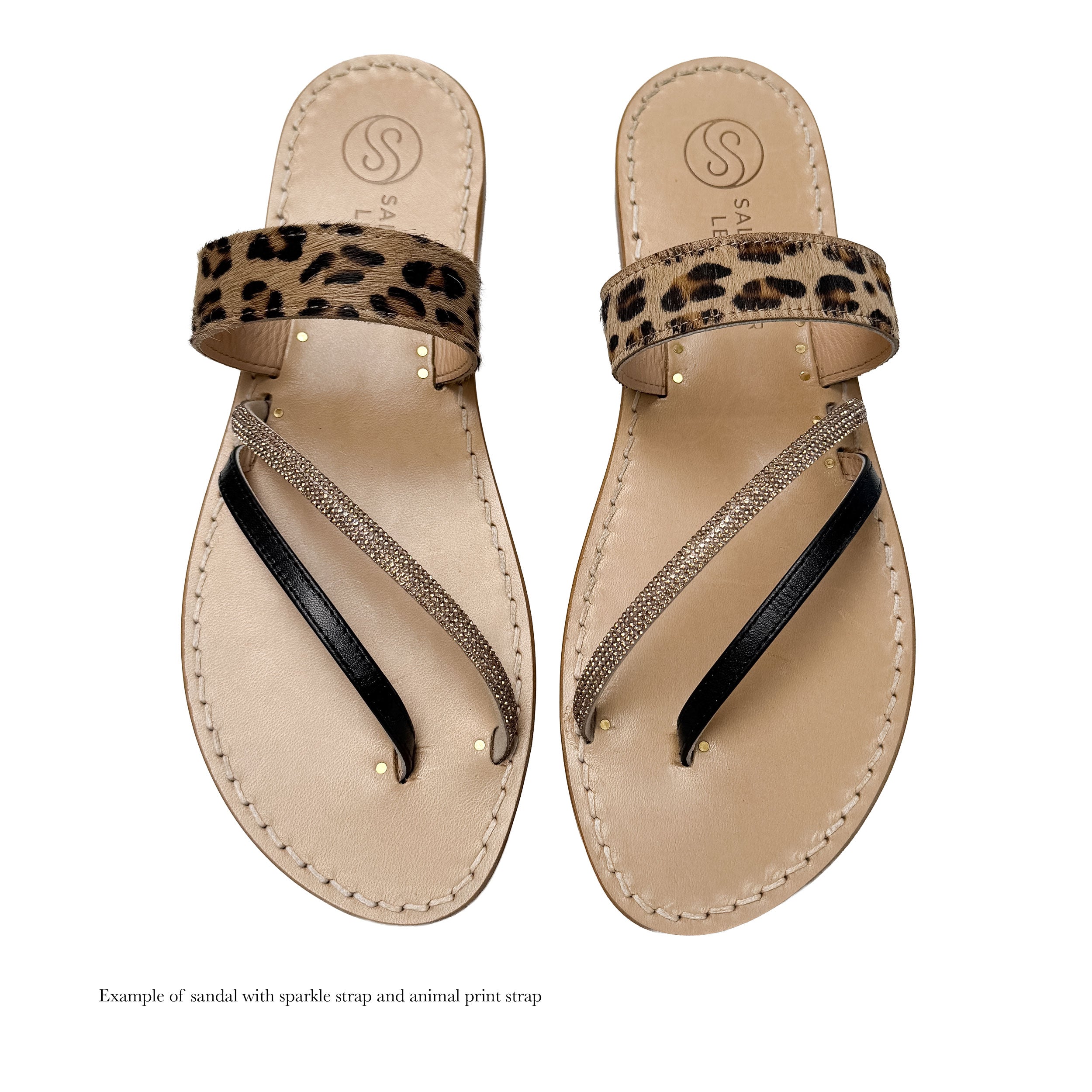 Pair of sandals with leopard print strap and sparkling details on a white background