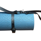 Blue perforated mat with black straps on a white background